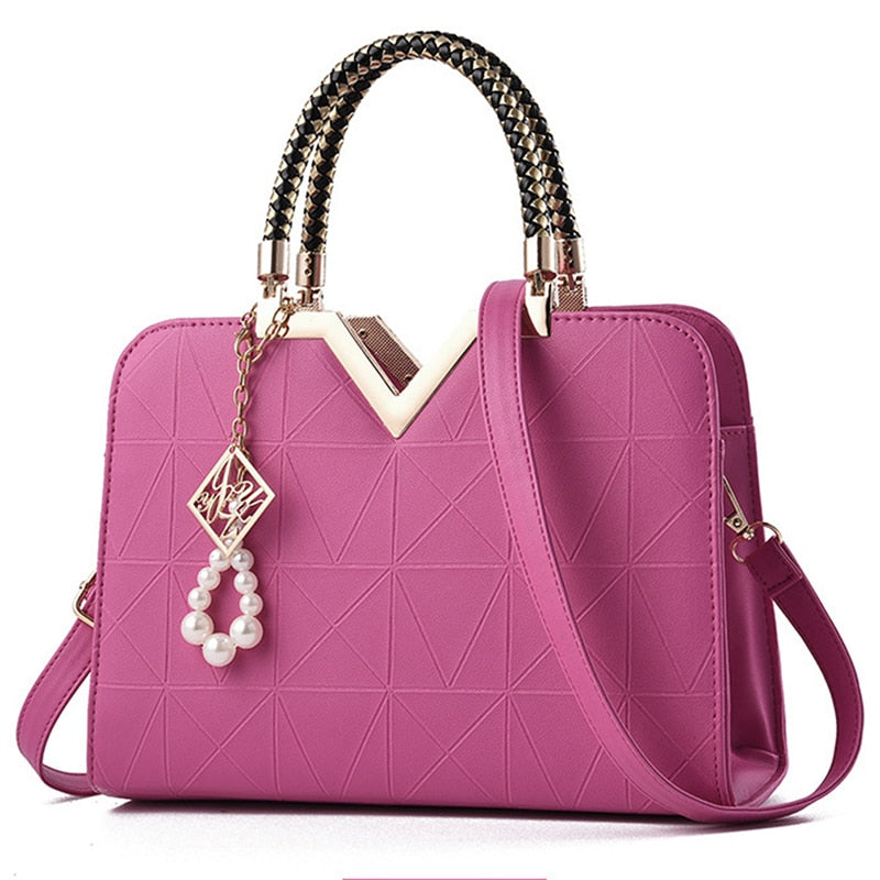 Elegant rose red women's handbag with gold accent handle and shoulder strap
