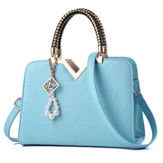 Elegant sky blue women's handbag with geometric pattern and shoulder strap
