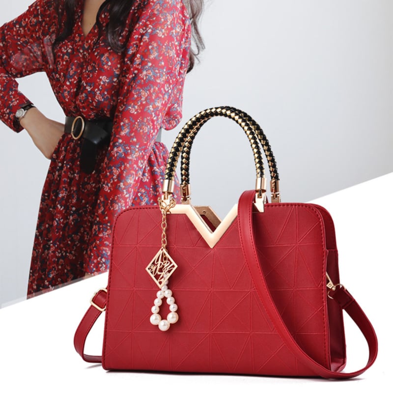 Elegant women's handbag in wine red color with top handle and shoulder strap
