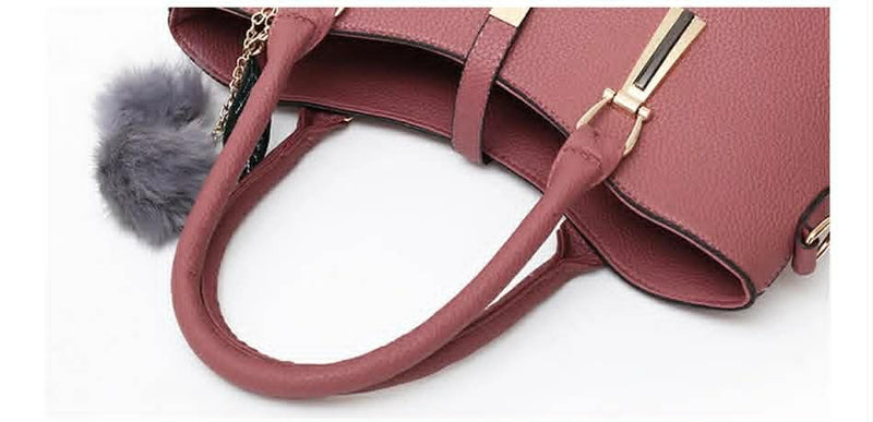 Close-up detail of pink handbag handles and premium textured leather finish
