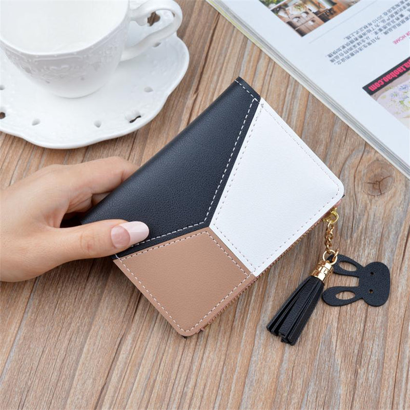 Black geometric women's wallet with card holder, coin pocket, and tassel pendant.
