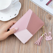 Pink geometric women's PU leather wallet with tassel charm and compact card holder.
