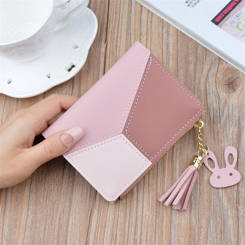 Pink geometric women's PU leather wallet with tassel charm and compact card holder.
