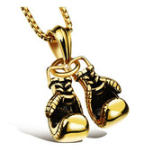 Gold boxing gloves necklace pendant on clean white background