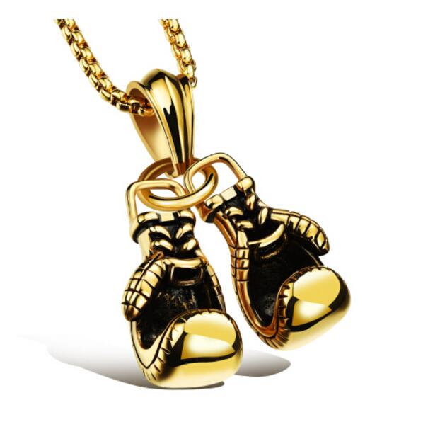 Gold boxing gloves necklace pendant on clean white background
