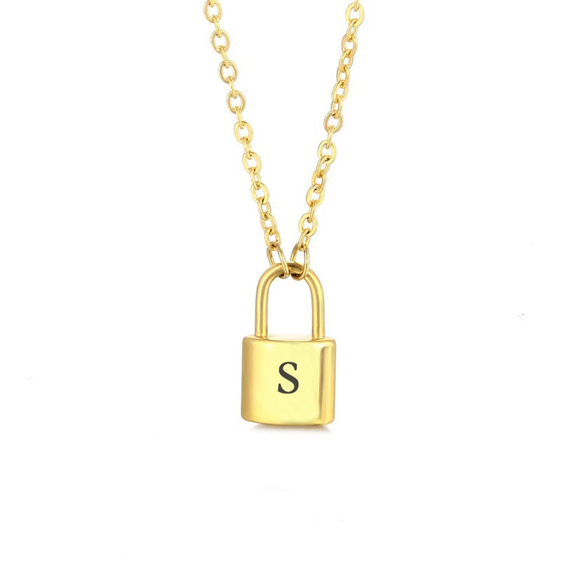 Gold initial lock necklace with letter S pendant on a minimal clean background 