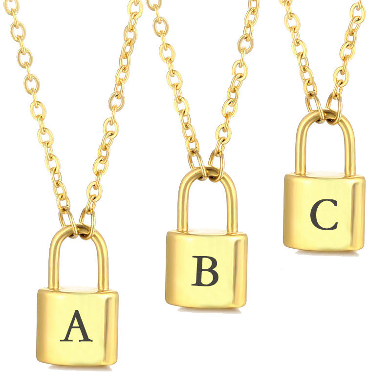 Gold initial lock necklac et with multiple letter pendants on a minimal background