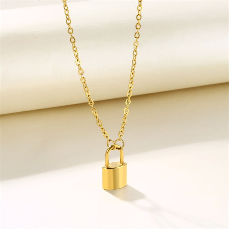 Minimalist gold lock necklace back view without engraving on neutral background