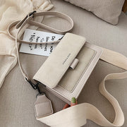 White Korean square crossbody bag with wide shoulder strap displayed on neutral fabric background
