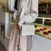 Minimalist white shoulder bag for women with wide comfortable strap
