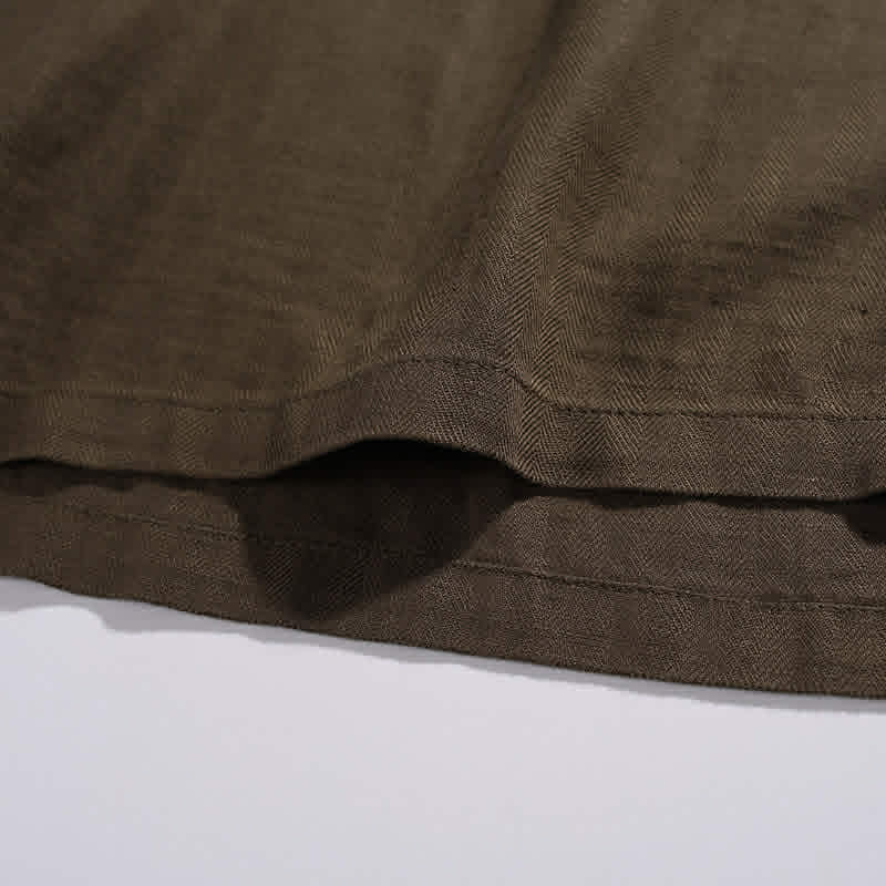 Bottom hem detail on men's relaxed fit cotton pocket t-shirt with durable stitching
