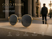 Classic round sunglasses with gold metal frame and full gray lenses styled for everyday fashion wear.

