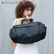 Woman carrying waterproof fitness and travel duffel bag outdoors
