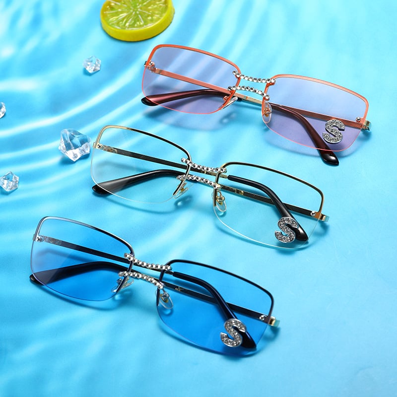 Luxury rimless sunglasses featuring pink, clear and blue lens options displayed on a water-inspired background

