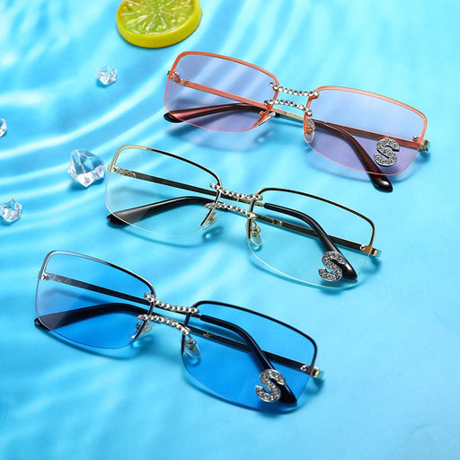 Luxury rimless sunglasses featuring pink, clear and blue lens options displayed on a water-inspired background
