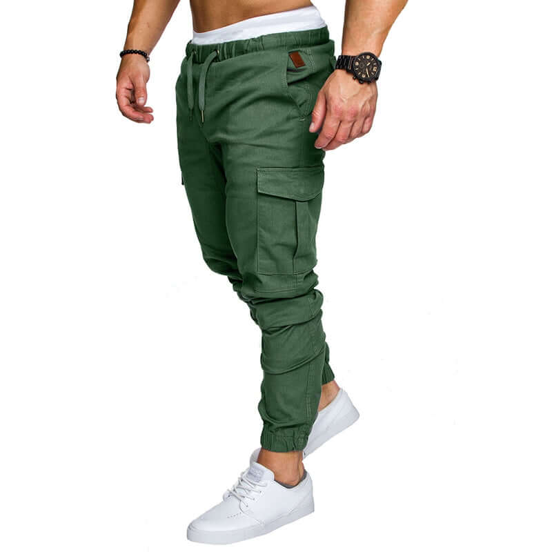 slim fir cargo joggers for men in green color, featuring side pockets and elastic cuffs, worn with white sneakers.