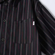 Functional chest pocket detail on men’s black retro striped loose fit short sleeve casual shirt.
