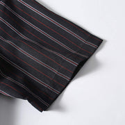 Short sleeve cuff detail of men’s black retro striped loose fit casual shirt showing quality craftsmanship.
