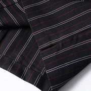 Premium fabric construction detail of men’s black retro striped loose fit casual shirt with retro vertical stripe pattern.
