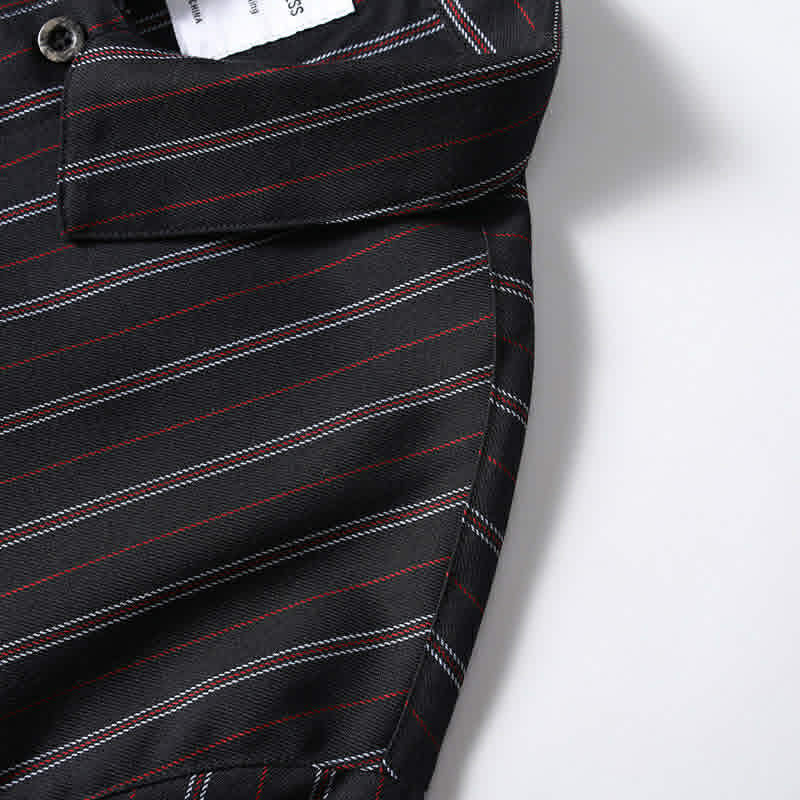 Side seam detail of men’s black retro striped loose fit casual shirt featuring durable stitching and relaxed silhouette.
