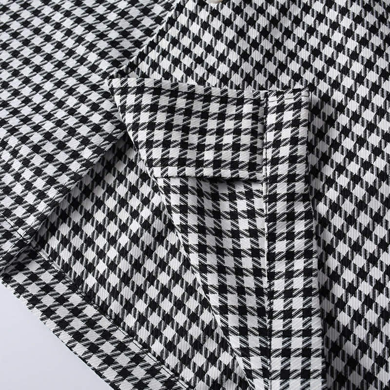 Close-up of hem stitching and fabric construction on men's black and white checkered shirt