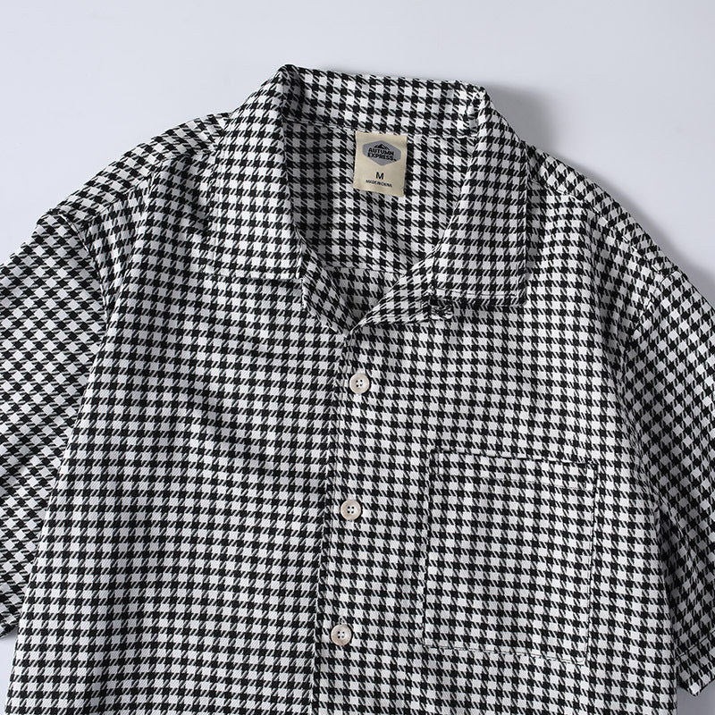 Close-up detail of men’s breathable checkered button-up Cuban collar shirt
