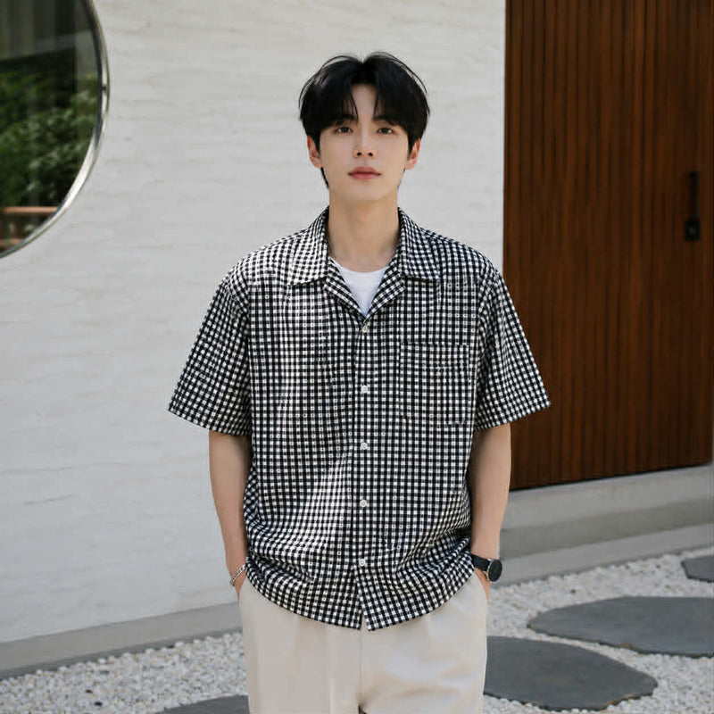 Men's black and white checkered Cuban collar short sleeve shirt styled for casual summer wear
