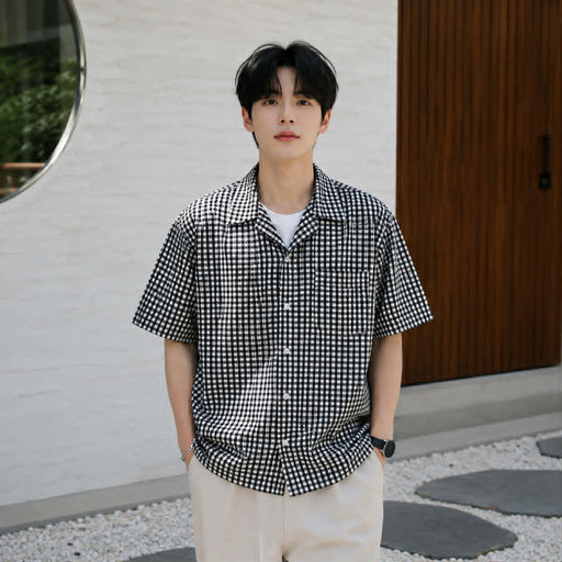 Men's black and white checkered Cuban collar short sleeve shirt styled for casual summer wear