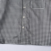 Front buttong placket on men's black and white checkered shirt