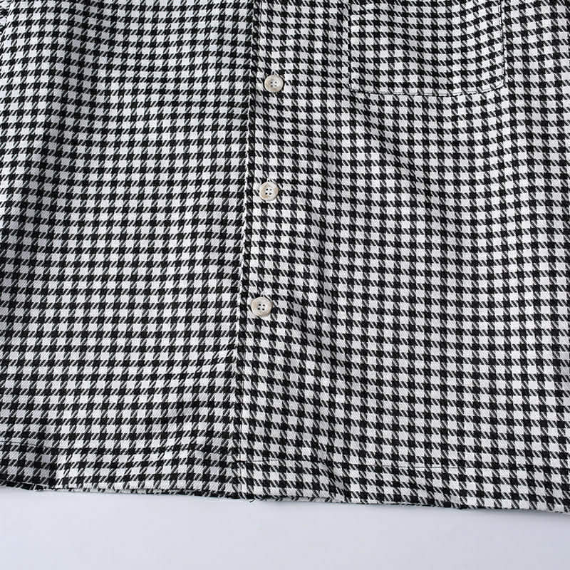 Front buttong placket on men's black and white checkered shirt