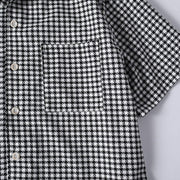 Functional chest pocket detail on men's black and white checkered shirt