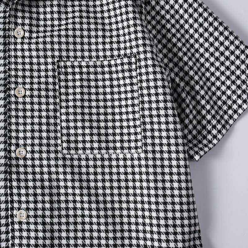Functional chest pocket detail on men's black and white checkered shirt