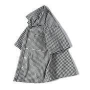 Angled vie of men's black and white checkerd short sleeve shirt