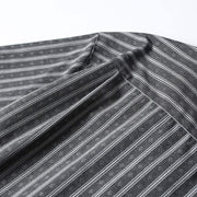 Back yoke construction detail on gray striped Cuban collar shirt highlighting premium tailoring and comfort fit.
