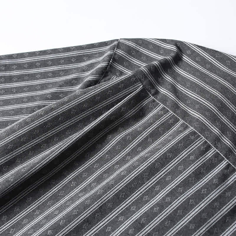 Back yoke construction detail on gray striped Cuban collar shirt highlighting premium tailoring and comfort fit.
