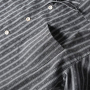 Chest pocket detail of gray retro Cuban collar striped short sleeve shirt with vintage stripe pattern and functional design.

