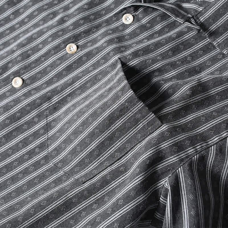 Chest pocket detail of gray retro Cuban collar striped short sleeve shirt with vintage stripe pattern and functional design.

