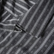 Premium Cuban collar close-up on gray striped short sleeve shirt with textured fabric and retro-inspired design.
