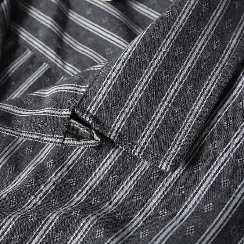 Premium Cuban collar close-up on gray striped short sleeve shirt with textured fabric and retro-inspired design.
