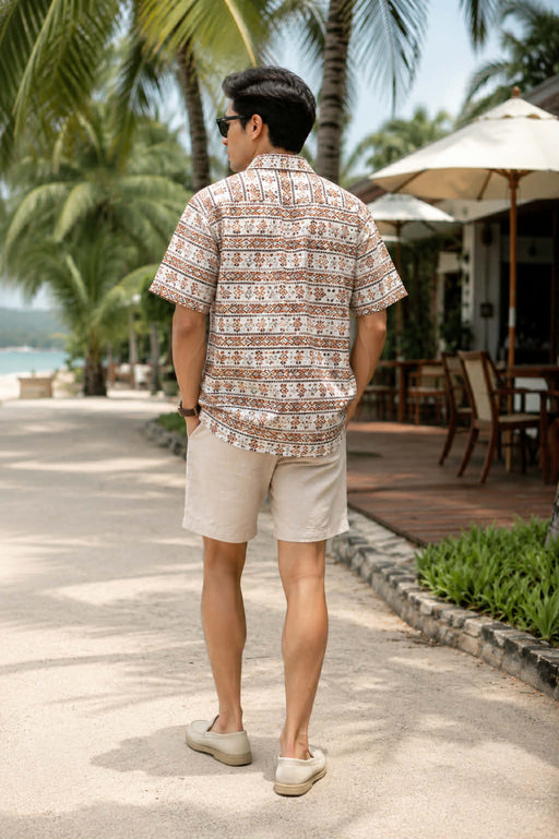 Back view of men’s Hawaiian print Cuban collar shirt with short sleeves and relaxed fit.
