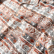 Detailed texture of lightweight Hawaiian print fabric with geometric pattern design.
