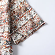 Sleeve detail of Hawaiian print Cuban collar shirt showing woven pattern and stitching.
