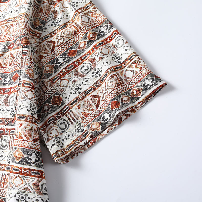 Sleeve detail of Hawaiian print Cuban collar shirt showing woven pattern and stitching.
