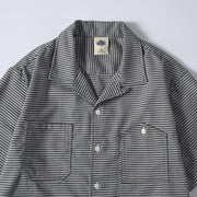 Close-up detail of men’s houndstooth Cuban collar shirt
