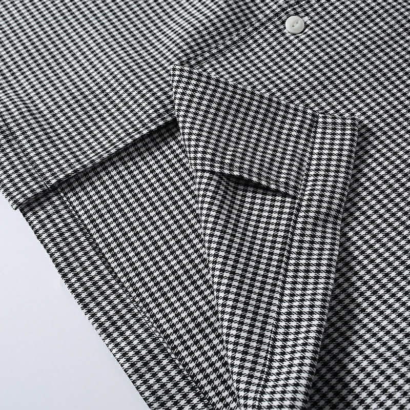 Hem detail of black en white houndstooth cuban collar shirt