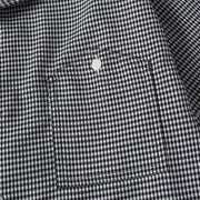 Close-up of chest pocket stitching and micro check fabric pattern on casual men’s shirt
