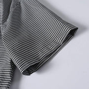 Sort sleeve detail of black and white chek cuban collar shirt