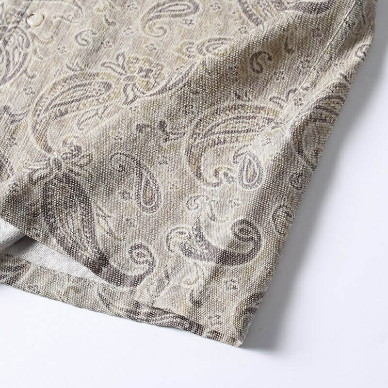 Bottom hem detail of men’s paisley print summer shirt with relaxed loose fit construction.
