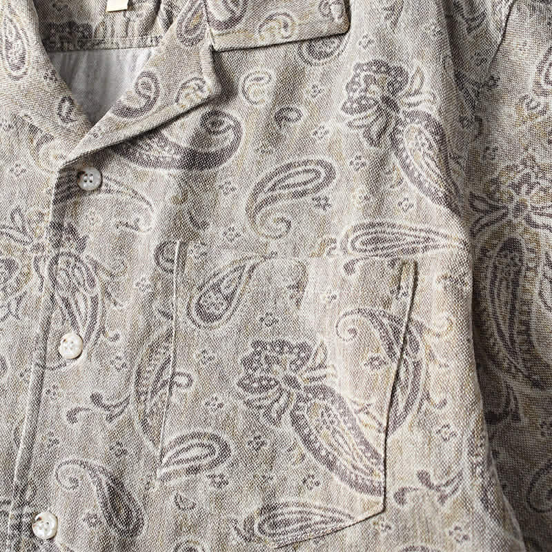 Chest pocket detail on men’s paisley Cuban collar shirt featuring vintage paisley print design.
