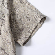 Short sleeve detail of men’s paisley Cuban collar shirt showing stitching and fabric finish.
